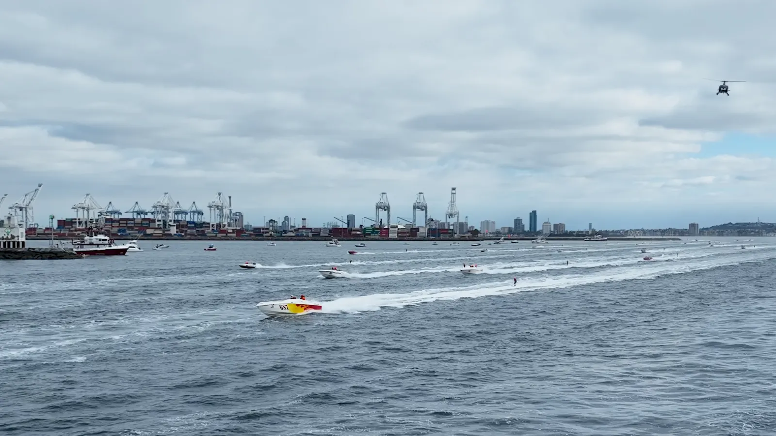 Race boat and skier crossing the open water near Long Beach