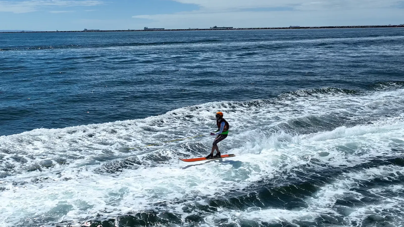 Skier holding the line behind a race boat