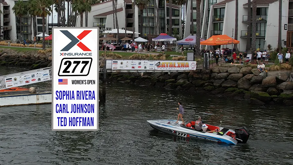 Race boat 277 passing spectators along the waterfront