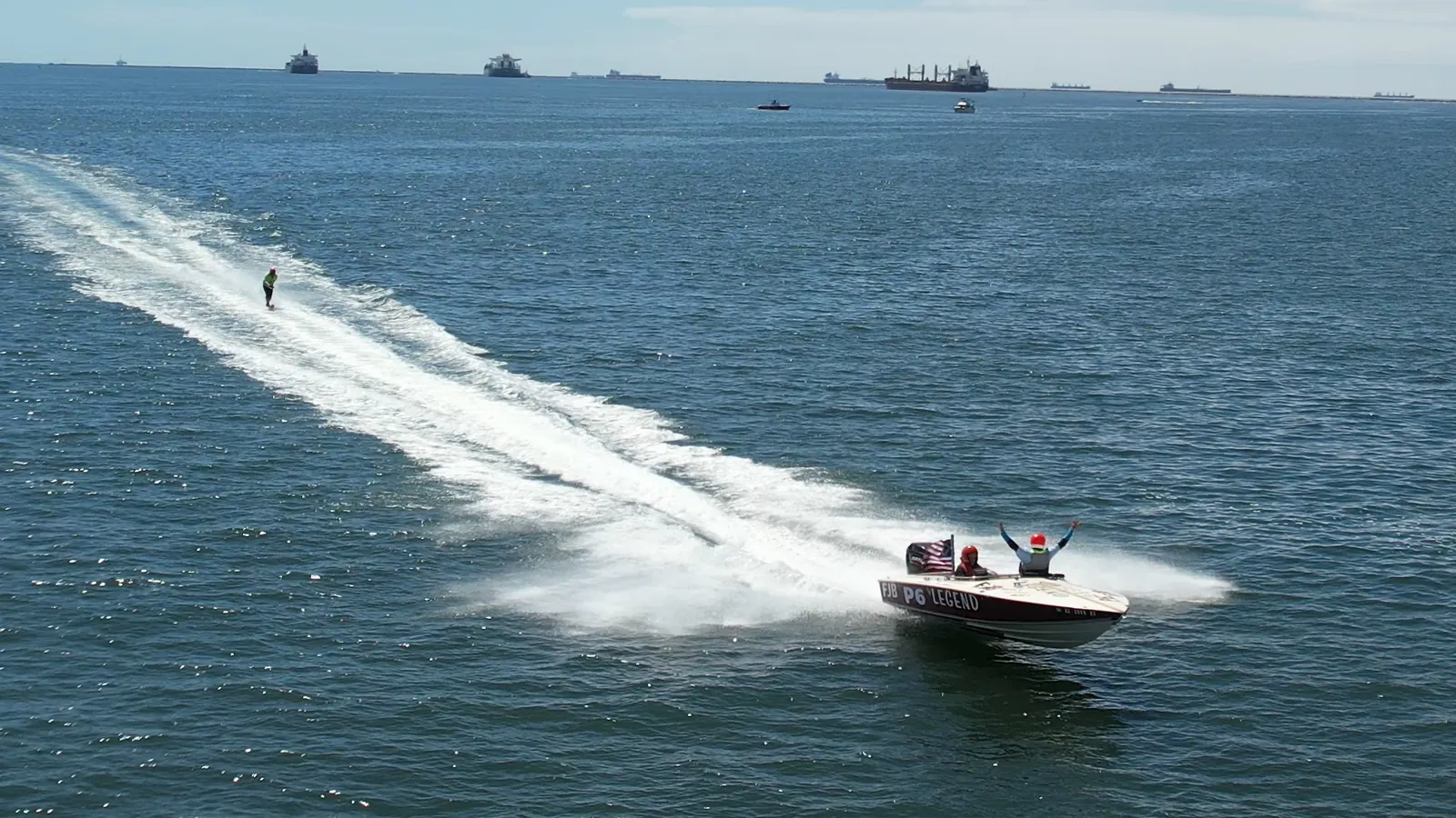 Race boat towing a skier through open water